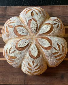 a loaf of bread sitting on top of a wooden cutting board