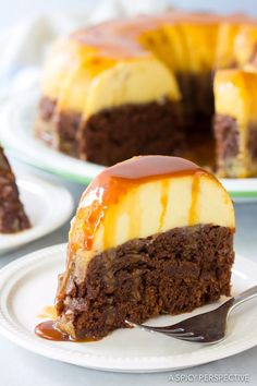 a slice of chocolate cake with caramel sauce on top and the rest of the cake in the background