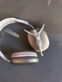 a pair of headphones sitting on top of a table next to a figurine