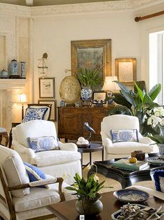 a living room with white furniture and blue accents on the walls is featured in an instagram