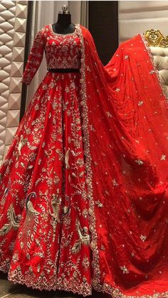 a red and gold wedding gown on display