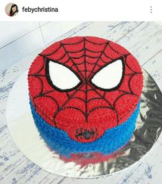 a spiderman cake is sitting on a plate