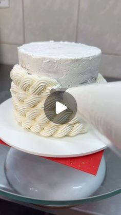 a white cake sitting on top of a plate