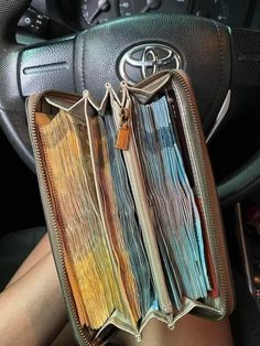 the interior of a car with an open book in it's pocket and two keys