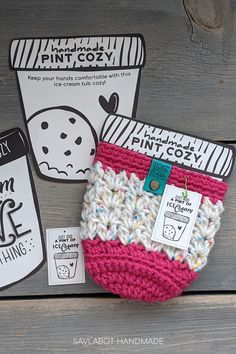 a crocheted cup cozy is sitting on a table next to two coffee cups