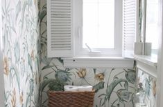 a white toilet sitting next to a window in a bathroom under a window sill