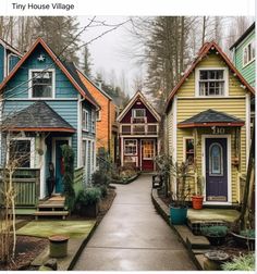 many colorful houses are lined up on the street in front of trees and bushes, along with one another