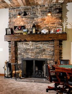 a living room with a fire place next to a dining table and chairs in front of a stone fireplace