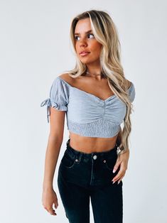 DETAILS: Our Morrilyn Crop Top is an off the shoulder crop top is loaded full of details. This top features a padded bust, smocked bodice, and off the shoulder neckline. The sleeves on this top feature elastic to give the top a more secure fit. This top has a lot of stretch throughtout if in between sizes we recommend sizing up. CONTENT & CARE: SELF: 100% Polyester SIZE & FIT: Model is 5'6" The model is wearing a size medium Fits true to size The Fabric has stretch Trendy Fitted Off-shoulder Smocked Top, Trendy Ruched Off-shoulder Top For Spring, Trendy Off-shoulder Smocked Top For Summer, Trendy Off-shoulder Smocked Summer Top, Spring Off-shoulder Tube Top With Smocked Bodice, Off-shoulder Smocked Bodice Tube Top For Spring, Spring Off-shoulder Smocked Bodice Tube Top, Summer Off-shoulder Crop Top With Smocked Bodice, Cropped Tube Top With Smocked Bodice