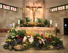 the altar is decorated with flowers, candles and a crucifix