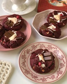 three plates with desserts on them sitting next to a cup and saucer filled with ice cream