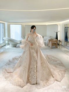 a woman in a wedding dress standing in a room