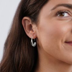 These earrings were designed to add a unique twist to the must-have gold hoop trend. Classic, timeless, and guaranteed to elevate any look. Silver plated Size: 1in x 0.8in Holds safely in the ear Lightweight Hypoallergenic, lead & nickel free If you aren't in LOVE with your purchase, please let us know within 30 days of receiving your item, and you'll receive a stress-free refund. Modern Twist Silver Hoop Earrings With Ear Wire, Modern Hypoallergenic Small Hoop Wrap Earrings, Modern Hypoallergenic Hoop Earrings, Modern Nickel-free Hoop Wrap Earrings, Chunky Silver Hoop Earrings, Wide Silver Ring, Chunky Silver Rings, Drop Hoop Earrings, Liquid Metal