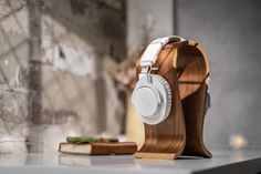 a wooden headphone stand sitting on top of a table