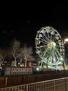 a ferris wheel is lit up at night