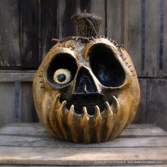 a carved pumpkin sitting on top of a wooden table