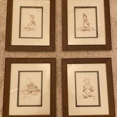 four framed pictures of winnie the pooh and tigger in brown frames on a carpeted floor