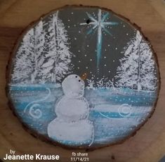 a snowman painted on a piece of wood