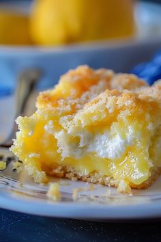 a close up of a piece of cake on a plate with lemons in the background