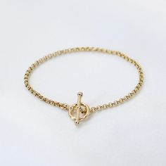 "14K GoldToggle Rolo Chain Bracelet - 14K Gold 2mm Rolo Chain Bracelet ★ 14K gold 2mm rolo chain ★ 14K gold toggle clasp ★ All components are 14K solid yellow gold The length includes the chain and the closure. Please measure your wrist before you place your order. ** How to choose a correct size of bracelet. 1. Measure your wrist below the wrist bone using a flexible tape measures, a string or a strip of paper. 2. If using a string or a strip of paper, mark length. Then, measure it with a ruler Gold Heart Bracelet, Mother Daughter Necklace, Tape Measures, Solid Gold Necklace, Daughter Necklace, Rolo Chain, Toggle Clasp, Solid Yellow, Chain Link Bracelet