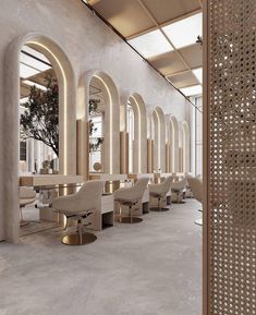 the interior of a restaurant with white walls and gold trimmings, chairs are lined up against an arched wall