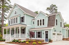 a large blue house with lots of windows