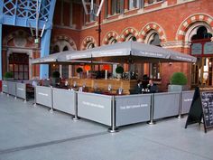 an outdoor bar with people sitting at it