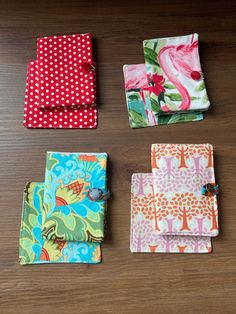 four different types of cloths laid out on top of a wooden table with polka dots