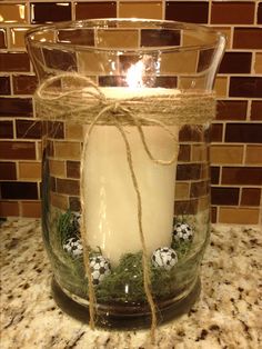 a candle is wrapped in twine and sitting on a counter