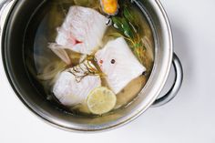 fish and lemons are cooking in a pot