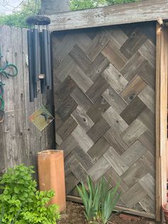 a wooden door in the middle of a garden with potted plants next to it