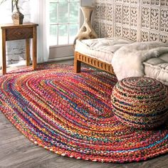 a living room with a large rug on the floor and a couch in the corner