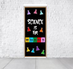 science is for wines poster in front of a white brick wall with colorful flasks on it