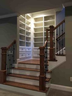 an empty room with some stairs and drawers