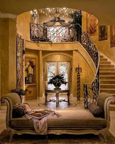 a living room filled with furniture and a spiral staircase