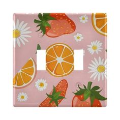 a pink light switch cover with oranges and daisies