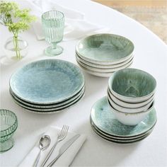 a table topped with plates and silverware