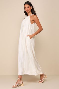 A sun-soaked vacay isn't complete without the Little Lies Ainsley Beige Pinstriped Linen Halter Maxi Dress with Pockets! Breezy, linen-blend woven fabric features a subtle pinstriped design as it shapes an adjustable, drawstring halter neckline with thick, tubular straps that tie above a keyhole cutout at the back. Relaxed bodice continues into a shift-style silhouette with side seam pockets and a maxi skirt with a fringe-adorned hem. Kick pleat at back. Fit: This garment fits true to size. Leng Spring Unlined Maxi Dress For Beachwear, Spring Beachwear Maxi Dress Unlined, Linen Beach Dress For Spring Day Out, Spring Linen Beach Dress For Day Out, Spring Day Out Linen Beach Dress, Breezy Unlined Beach Dress For Spring, Spring Breezy Unlined Beach Dress, Spring Linen Maxi Dress For Day Out, Bohemian Linen Dress For Summer Day Out