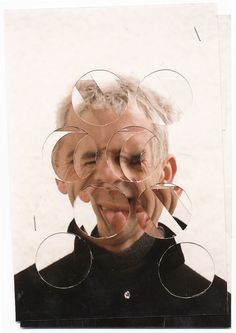 an old man making faces with circles on his face and fingers in front of him