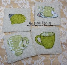 four coasters with tea cups on them