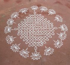 an intricate design is drawn on the ground with white chalk and markers to make it look like flowers