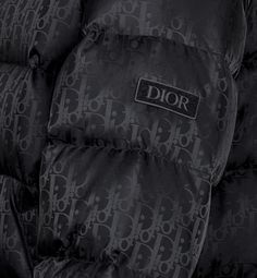 The black technical jacquard down jacket pays tribute to House heritage with a tonal Dior Oblique motif. Both modern and relaxed, it features a two-way zip closure with double pulls, a Dior soft patch on the sleeve and insulating goose down filling. The down jacket will lend a hallmark touch to any outfit.. 52 Cold Pics, Dior Coat, Apparel Design Inspiration, Denim Swimsuit, Dior Jacket, Pretty Sneakers, Designer Jackets For Men, Dior Star, Icon Shoes