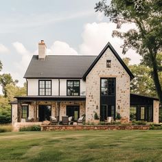 a large house sitting on top of a lush green field