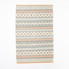 a gray and orange striped rug on a white background