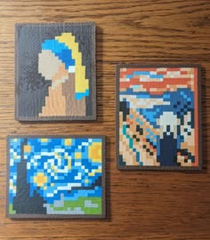 three pieces of art made out of legos sitting on a table next to each other