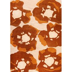 an orange and white rug with large flowers on the side, in front of a white background