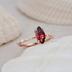 "Descriptions Center Stone: 1.3 Carat Marquise Cut Garnet, 10X5mm Marquise Cut Accent Stone: 0.2ct Moissanite(14k Gold) or Cubic Zircon(Silver) Material: Silver Only/Rose gold plated/White gold plated/Yellow gold plated/ Solid 14K/18K Gold in Rose gold/ Yellow gold/White gold Shank Width: approx. 1.6mm(Bottom) It can be made in any ring size. However please contact me to custom make it to a special big or small size. It can be made in white gold, rose gold or yellow gold with 14k or 18k.  The ri Marquise Cut Gemstone Jewelry For Proposal, Wedding Solitaire Garnet Rings, Marquise Gemstone Jewelry For Proposal, Wedding Garnet Solitaire Rings, Wedding Ruby Ring With Accent Stones In Marquise Shape, Marquise Ruby Ring With Accent Stones For Wedding, Wedding Ruby Ring With Marquise Shape And Accent Stones, Marquise Gemstone Ring For Proposal, Rose Gold Marquise Gemstone Wedding Ring