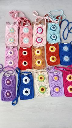 several crocheted purses are lined up on a table with one bag in the middle