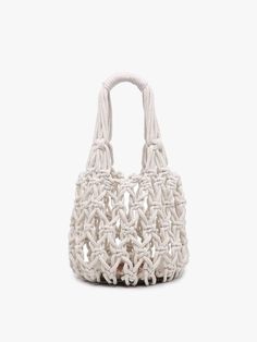 a white handbag on a white background with no one around it and the handle is made out of rope