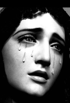 a black and white photo of a woman with tears on her face